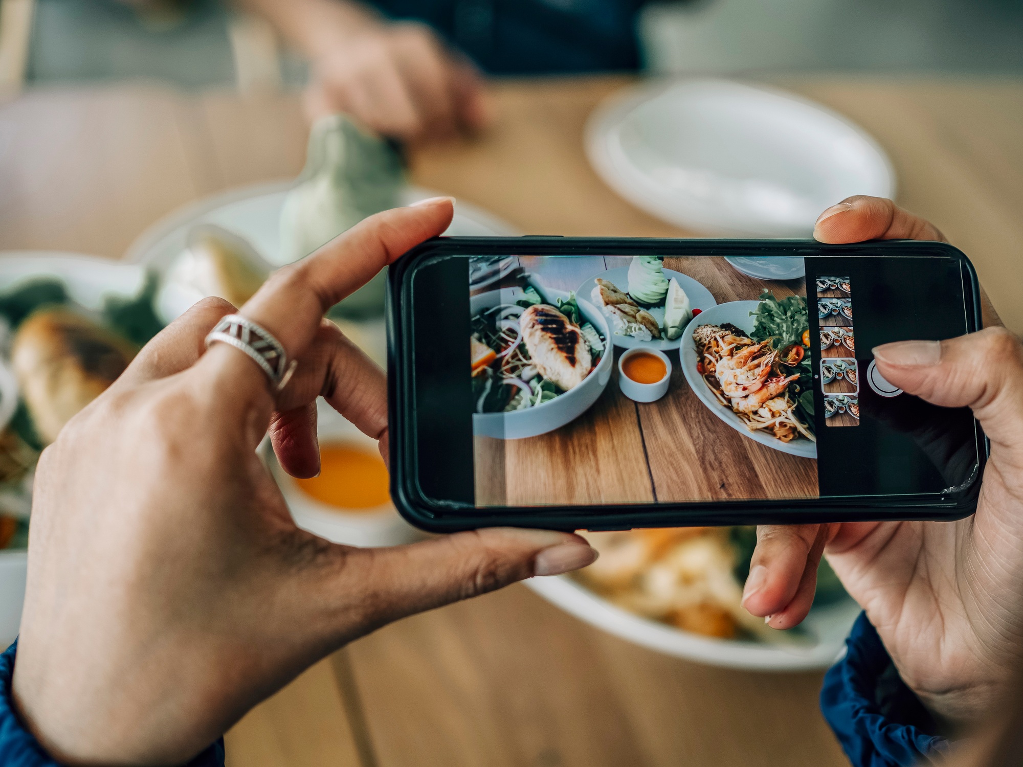 Close up people take the picture of food by smartphone, upload on social media